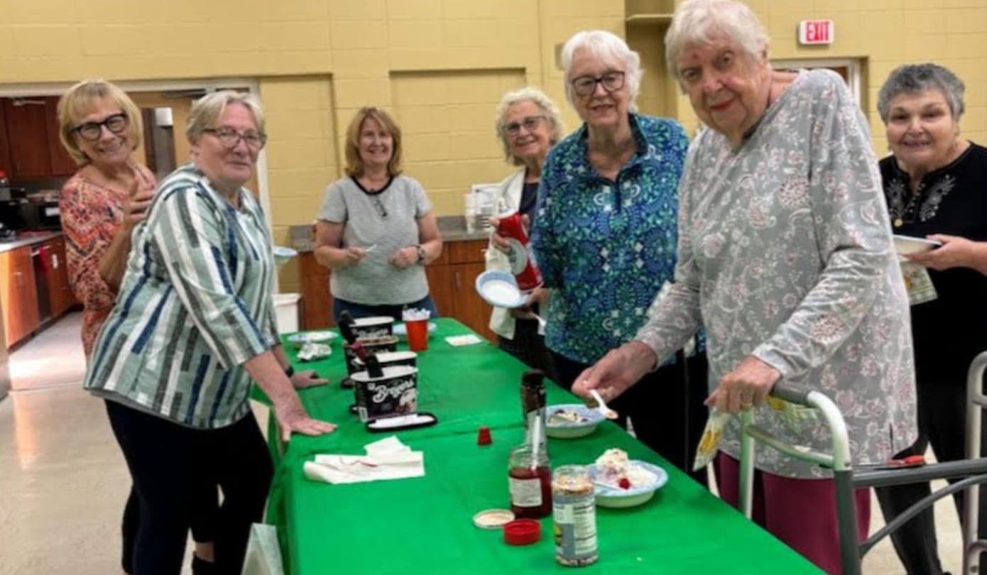 Members enjoy ice cream sundaes at the club’s season-opening gathering.
