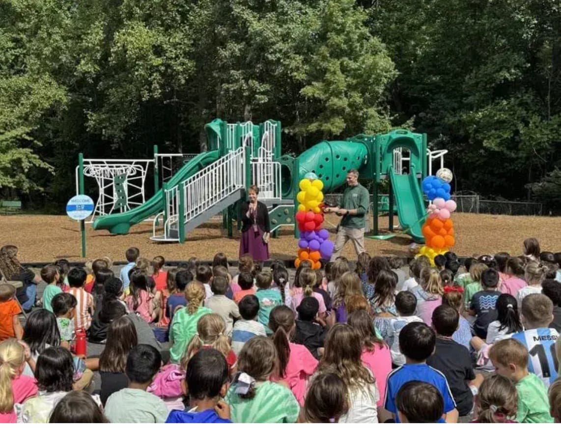 Students gather to celebrate the opening of the new playground at Mary Kay McMillin Early Childhood Center.